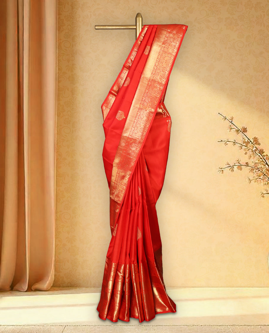 Red colour pure Kancheepuram saree with gold zari Banarasi mango motifs on the body, traditional border with elephant, floral, peacock and chackram motifs grand pallu with peacock and chackra pattern paired with matching blouse