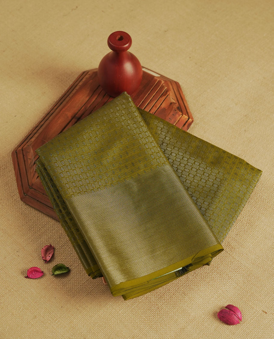 Military olive colour semi silk saree featuring neem zari Brocade Pattern all over the body, complemented by a Self Colour woven border with detailing, Pallu & blouse.