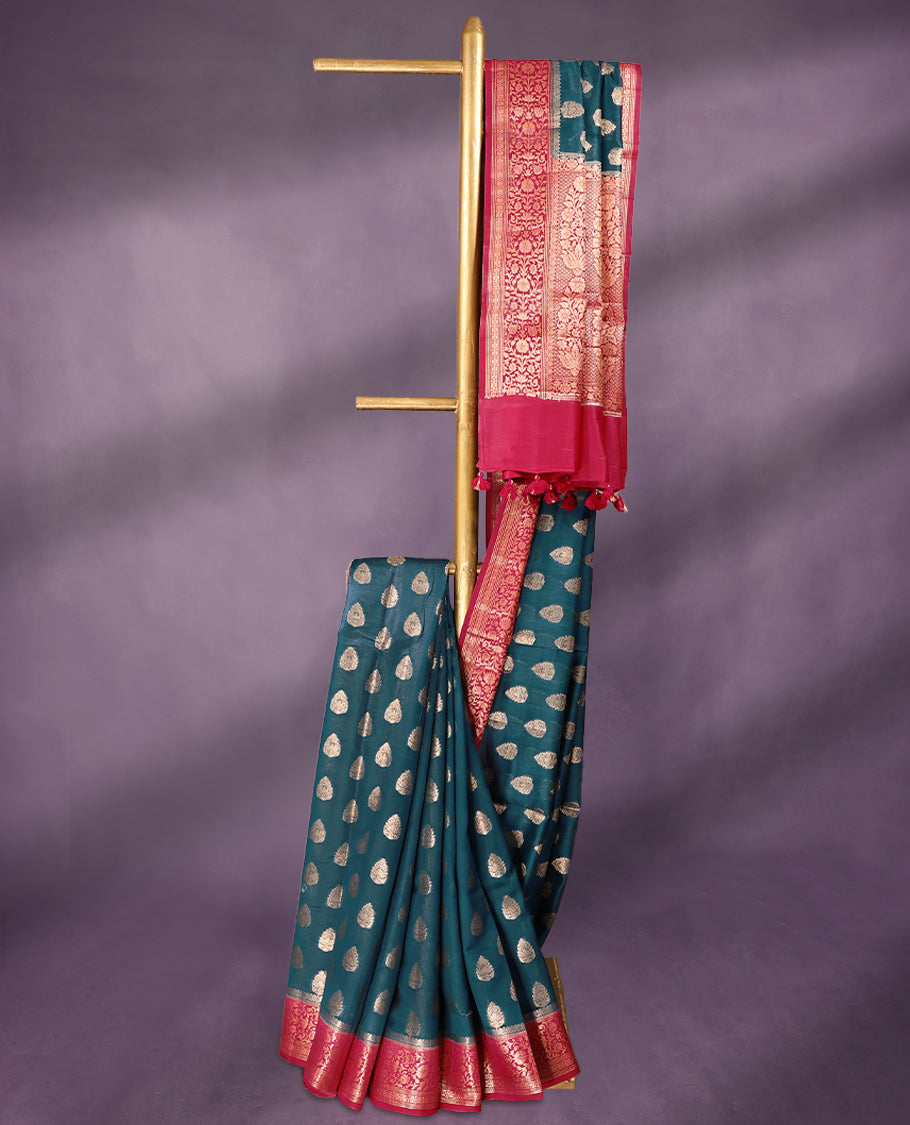 German Blue colour pure Banarasi Chanderi cotton fabric, featuring traditional antique zari buttas on the body, complemented by a traditional Rani Pink Colour border and a matching blouse.