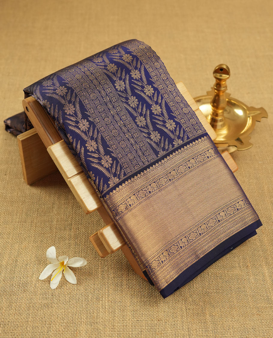 Dark violet colour Kanchipuram pattern Manthrakodi saree adorned with intricate geometrical zari floral weaving, complemented by an antique traditional zari border and a plain blouse piece with matching zari border.