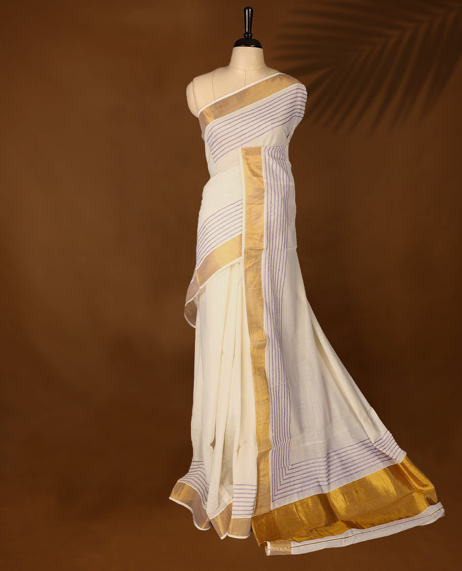 Elegant off white colour cotton Kerala saree featuring lavender colour Thread detailing on body, gold zari traditional kasavu border, Paired with matching blouse offering a classic and graceful look