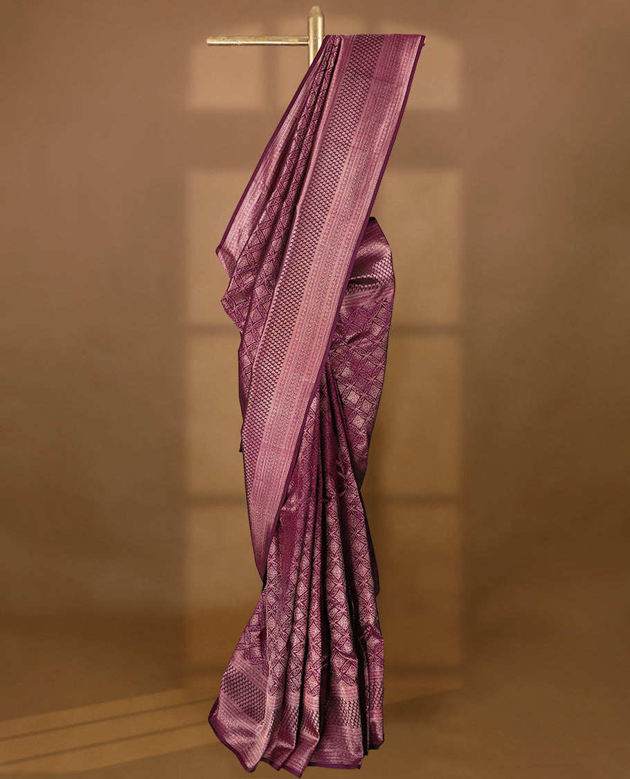 Mulberry purple Colour Manthrakodi saree featuring Antique Zari geometric brocade pattern on the body, complemented by a brocade border and a matching self coloured blouse.