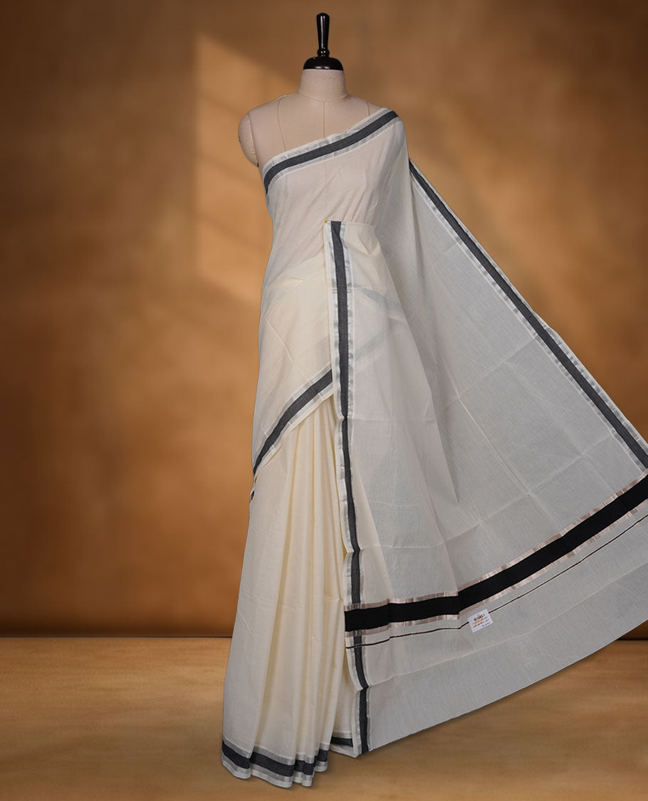 Off-white colour cotton Kerala saree with a subtle silver and black kasavu border, featuring a clean plain body, paired with a matching blouse.