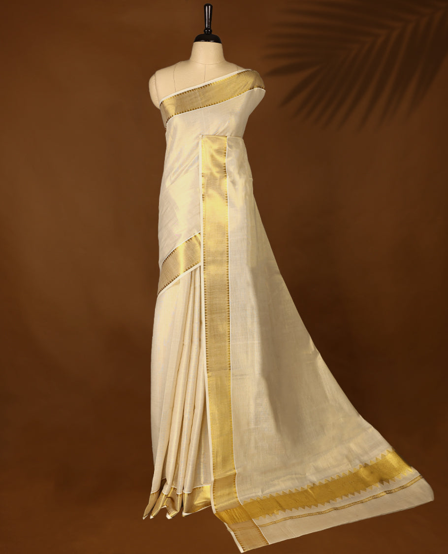 Elegant Light Gold colour Tissue Kerala saree featuring Plain body and traditional golden zari kasavu border offering a classic and graceful look, paired with a matching blouse.