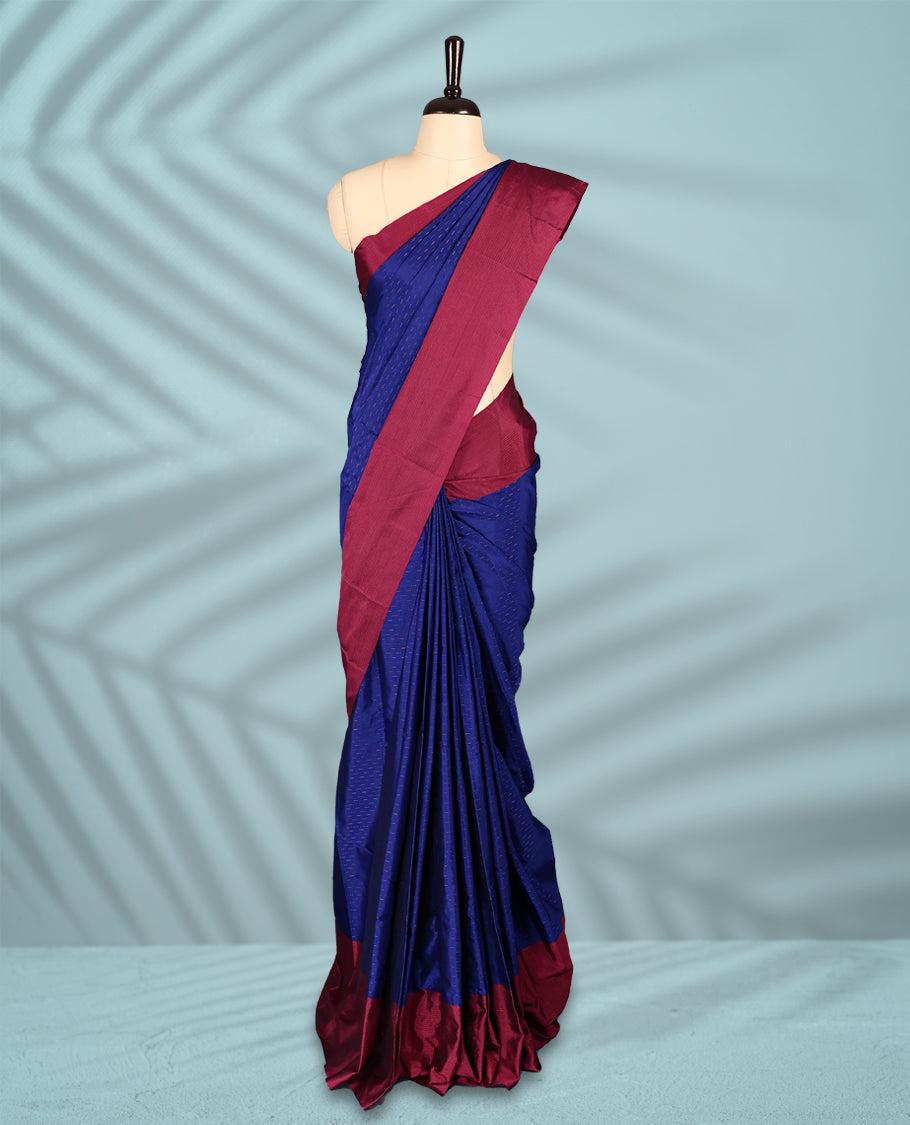 Royal blue Colour semi silk saree is adorned with a subtle copper zari pattern and beautifully offset by a rich wine border, paired with a matching blouse