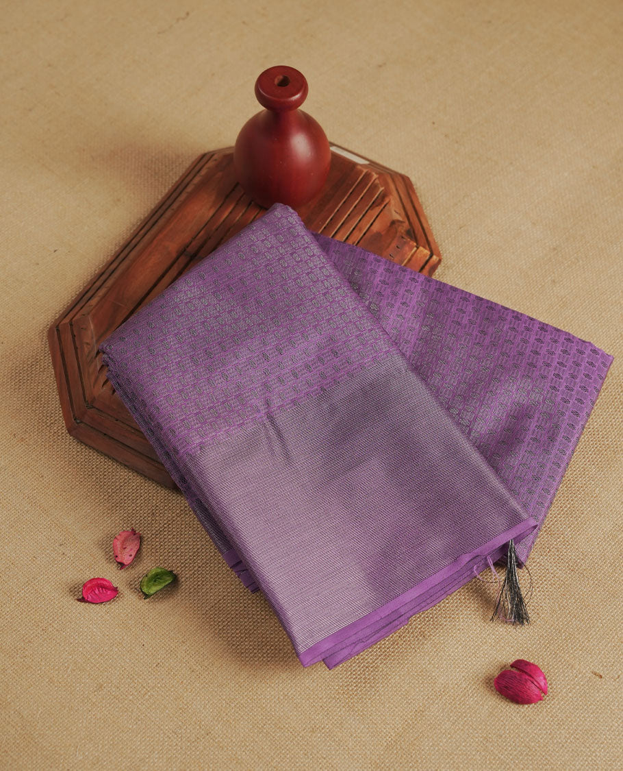 Lavender colour semi silk saree featuring neem zari Brocade Pattern all over the body, complemented by a Self Colour woven border with detailing, Pallu & blouse.