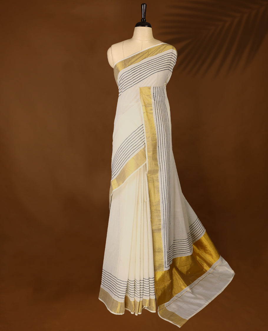 Elegant off white colour cotton Kerala saree featuring Blue colour Thread detailing on body, gold zari traditional kasavu border, Paired with matching blouse offering a classic and graceful look, paired with a matching blouse.