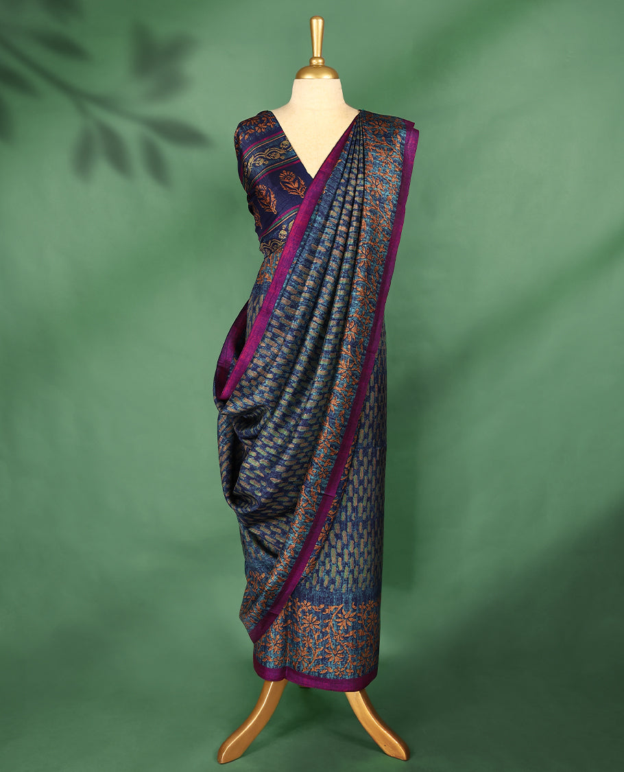 Blue Colour Manipuri saree features a brick patterned body in olive and indigo hues, beautifully offset by a contrasting magenta border with copper floral-printed, and comes with a matching blouse.