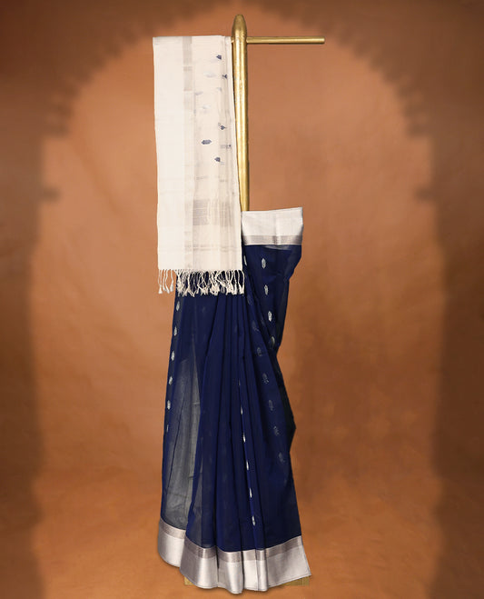 Deep Blue colour Maheshwari Cotton saree featuring Antique Zari Patterns across the entire body, complemented by a traditional White coloured border & Pallu, with a matching blouse.