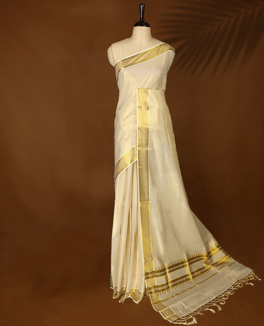 Elegant Light Gold colour Tissue Kerala saree featuring Plain body and traditional golden zari kasavu border, Rich pallu offering a classic and graceful look, paired with a matching blouse.