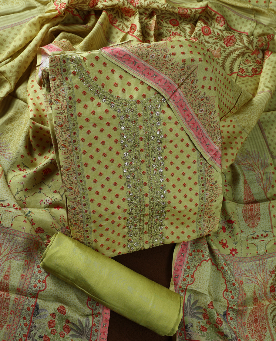 Olive green colour churidhar material adorned with subtle red prints and intricate embroidery on the neckline, paired with a beautifully printed dupatta and plain matching bottom.