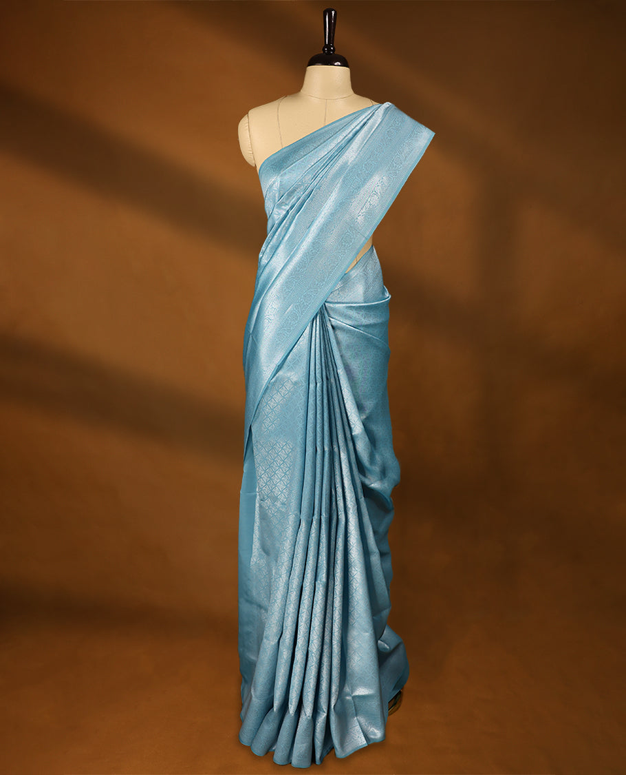 Light Blue coloured semi silk saree featuring a Silver coloured Zari Diamond design on the body, paired with a Self coloured border and matching blouse.