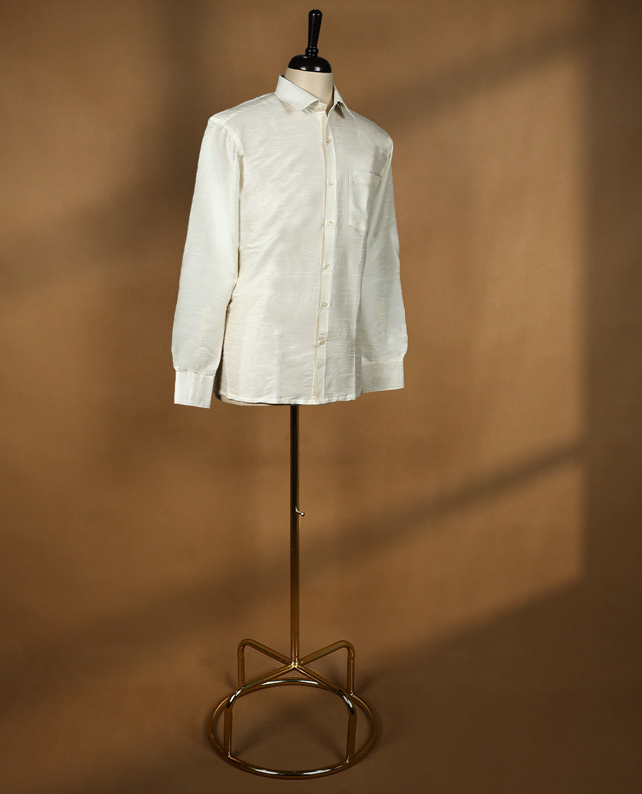 Off White colour DH men's shirt crafted from semi silk fabric, featuring a smooth glossy finish, classic collar, full sleeves, and a chest pocket perfect for festive and traditional wear.