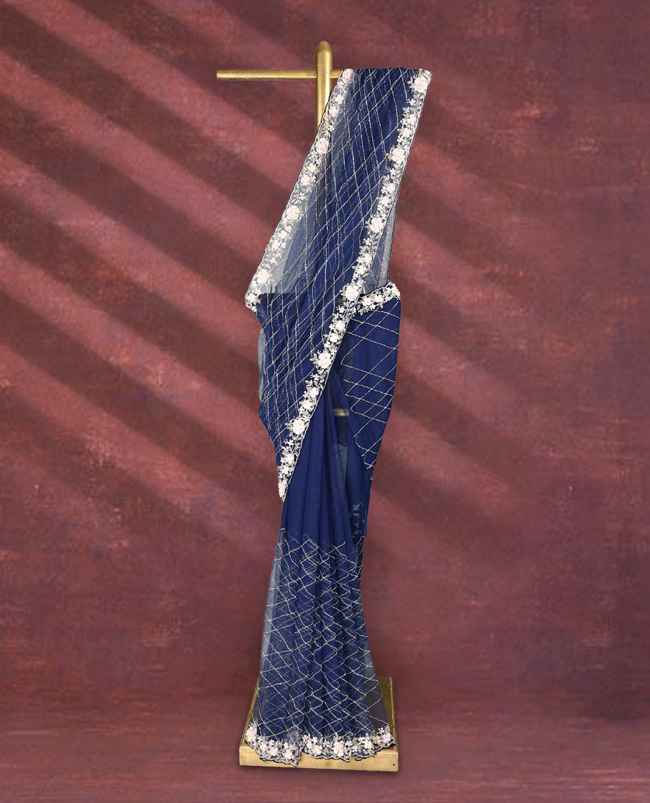 Navy Blue colour net designer saree featuring crisscross cut beads detailing on the body, adorned with beads and sequin worked floral kodi scallop border, paired with a matching worked blouse