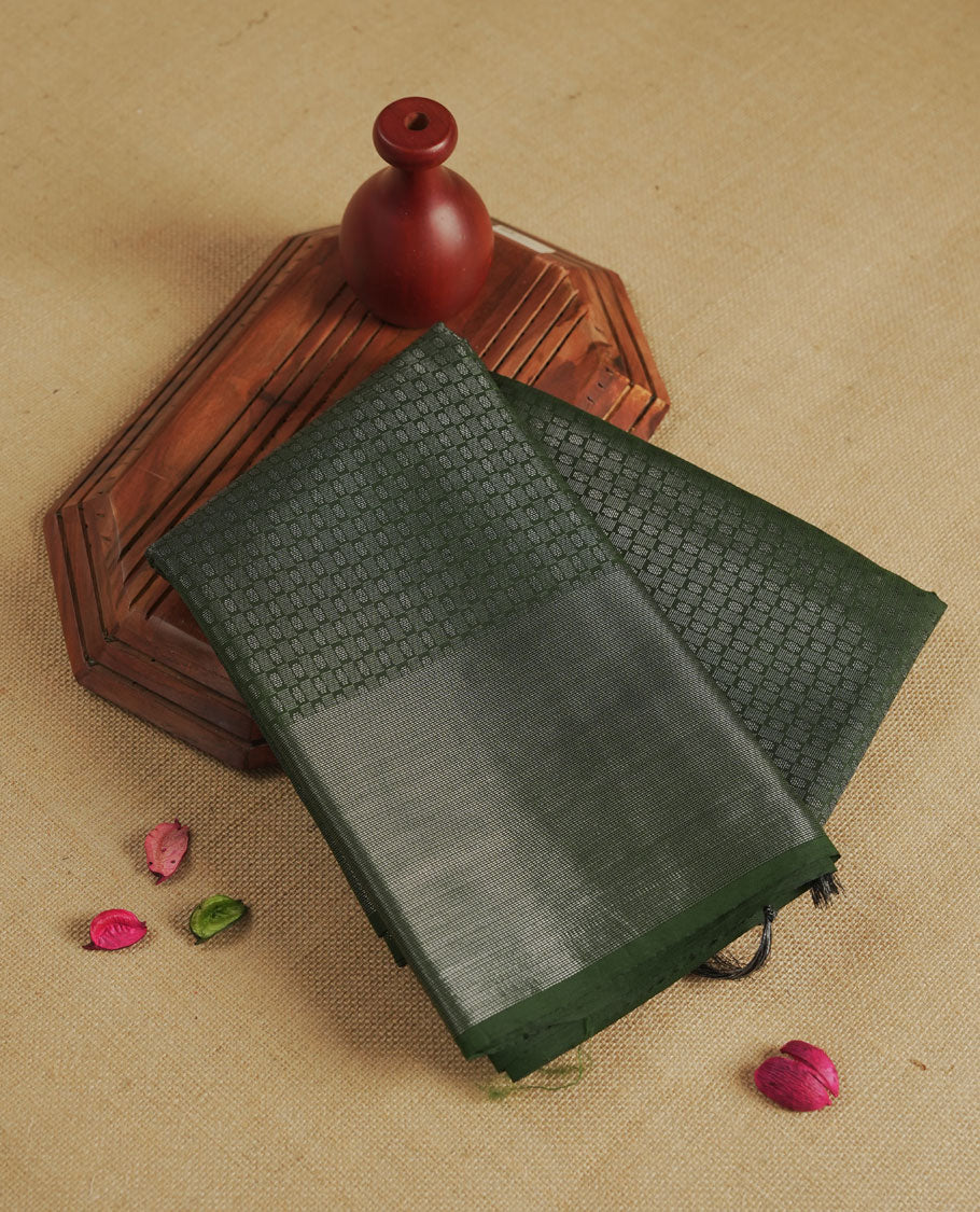 Dark green colour semi silk saree featuring neem zari Brocade Pattern all over the body, complemented by a Self Colour woven border with detailing, Pallu & blouse.