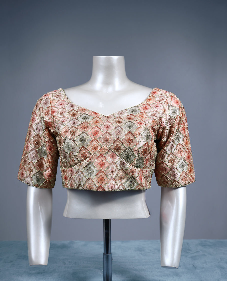 Multicolour designer padded readymade blouse featuring a pastel diamond patterned brocade in soft shades of peach, green, and beige, enhanced with subtle gold zari highlights and elbow length sleeves