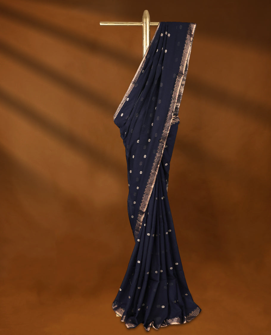 Deep Navy blue colour soft khadi cotton saree with small Beige Zari Flower motifs on the body, detailed woven Gold zari border, paired pallu with tussles, with matching blouse.