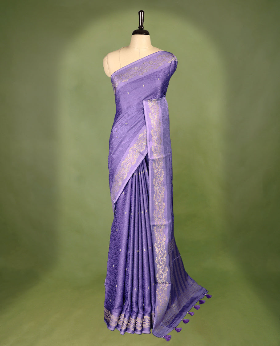 Pastel Purple colour pure Banaras crepe saree showcases elegant Gold & Silver zari Motifs all over the body, a traditional gold & Silver zari border, a rich intricately woven pallu, and comes with a matching blouse.