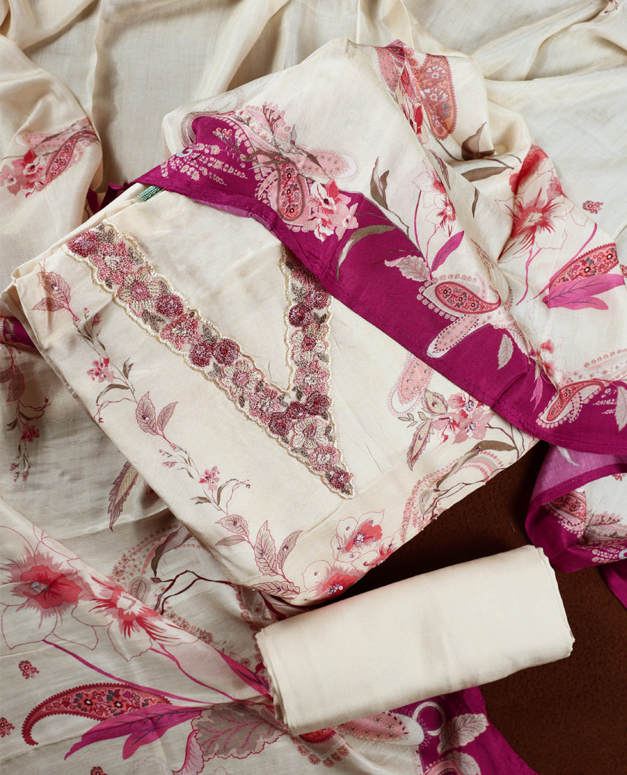 Cream colour churidhar material with pink floral and paisley prints, enhanced by a dark magenta border and delicate embroidery & Comes with matching plain bottom and dupatta.