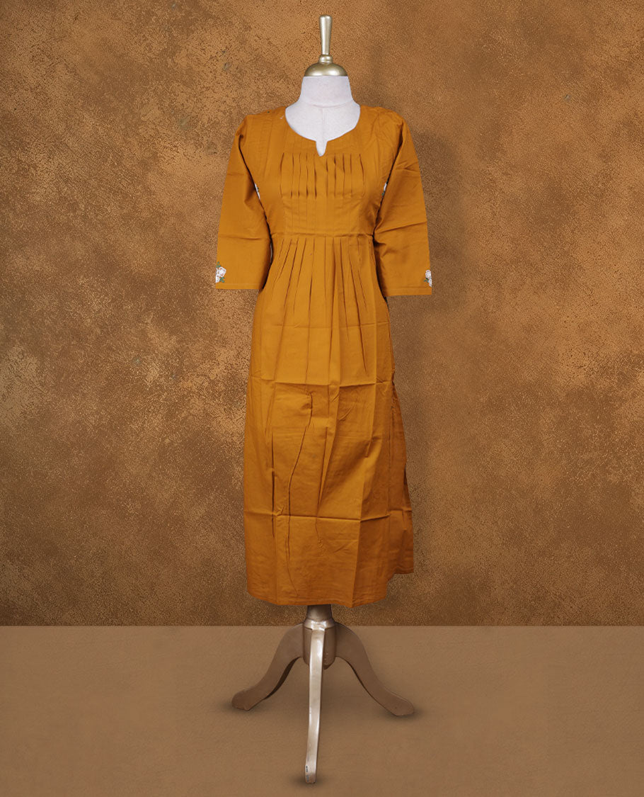 Mustard colour kurti with white colour colour thread pattern a sleeve , knee length design, styled with a around with slit neckline and a sleeve .