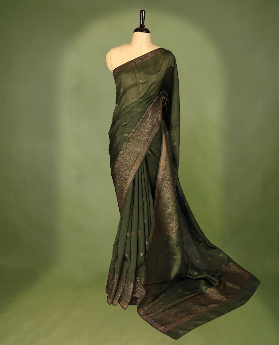 Army Green semi-Banaras tussar georgette saree adorned with antique zari floral motifs on the body, beautifully highlighted with a pencil art garden-inspired border, paired with a matching blouse.