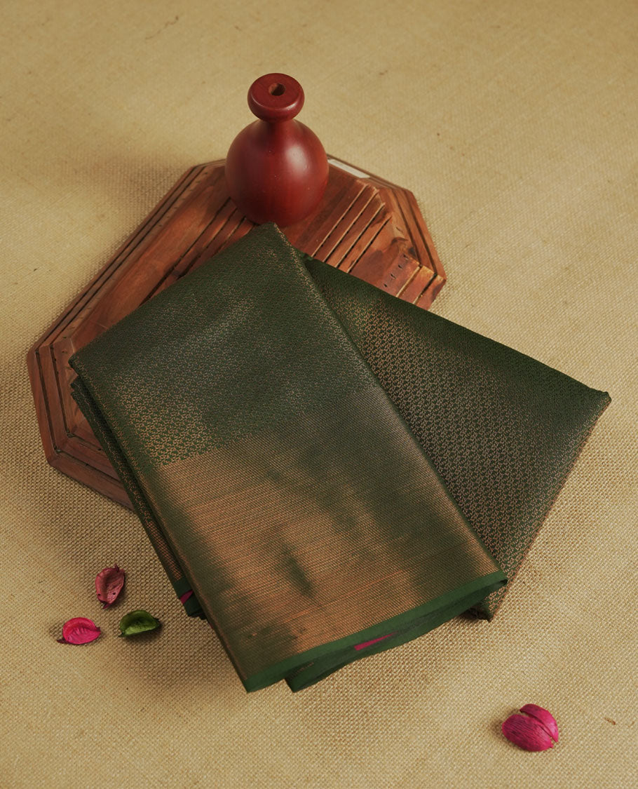 Dark Green colour semi silk saree featuring neem zari Brocade Pattern all over the body, complemented by a Self Colour woven border with detailing with contrast maroon Colour Pallu & blouse.