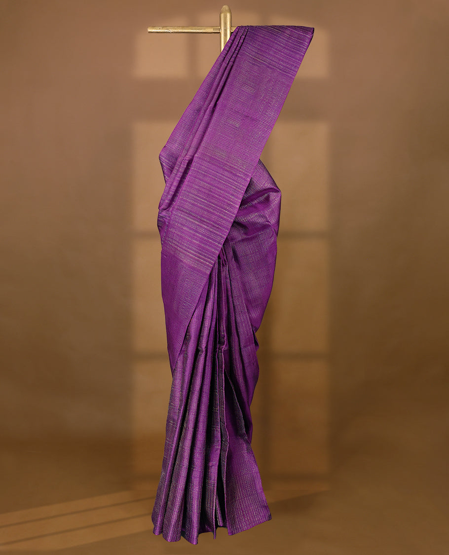 Violet coloured Manthrakodi saree featuring a multicoloured zari jacquard body, complemented by a self coloured turning Banarasi border and a matching self coloured blouse.