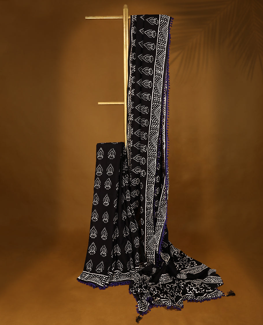 Black cotton saree features intricate white handblock prints, a beautifully detailed border with Violet piping and Self Coloured Blouse