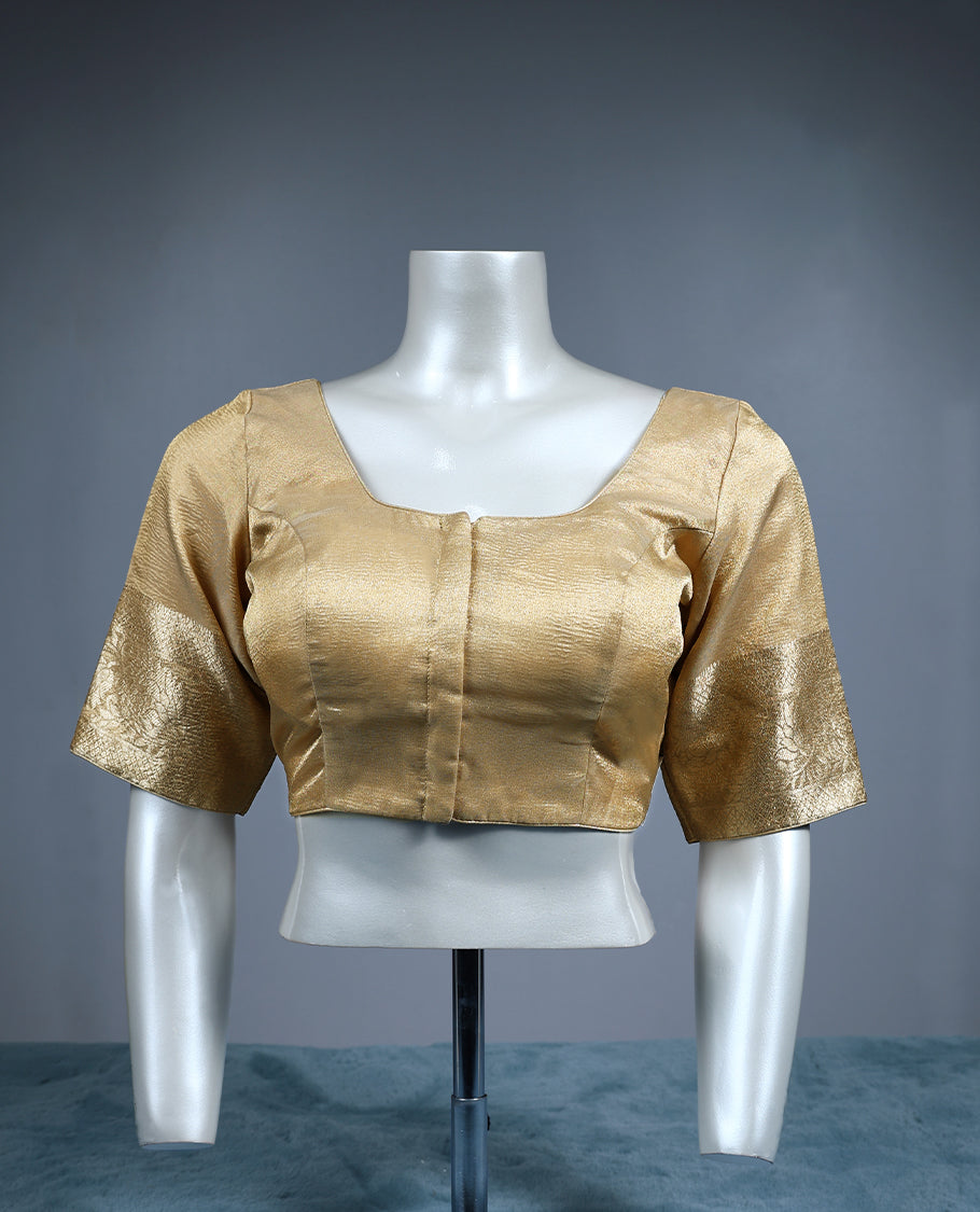 Golden tissue padded readymade blouse with a subtle sheen, highlighted by elbow length zari woven sleeves and a square neckline an elegant versatile piece ideal for silk and festive sarees.