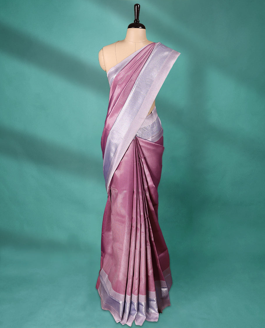 Pastel Onion coloured semi silk saree featuring a Check design on the body, paired with a Baby Blue coloured border and matching blouse.