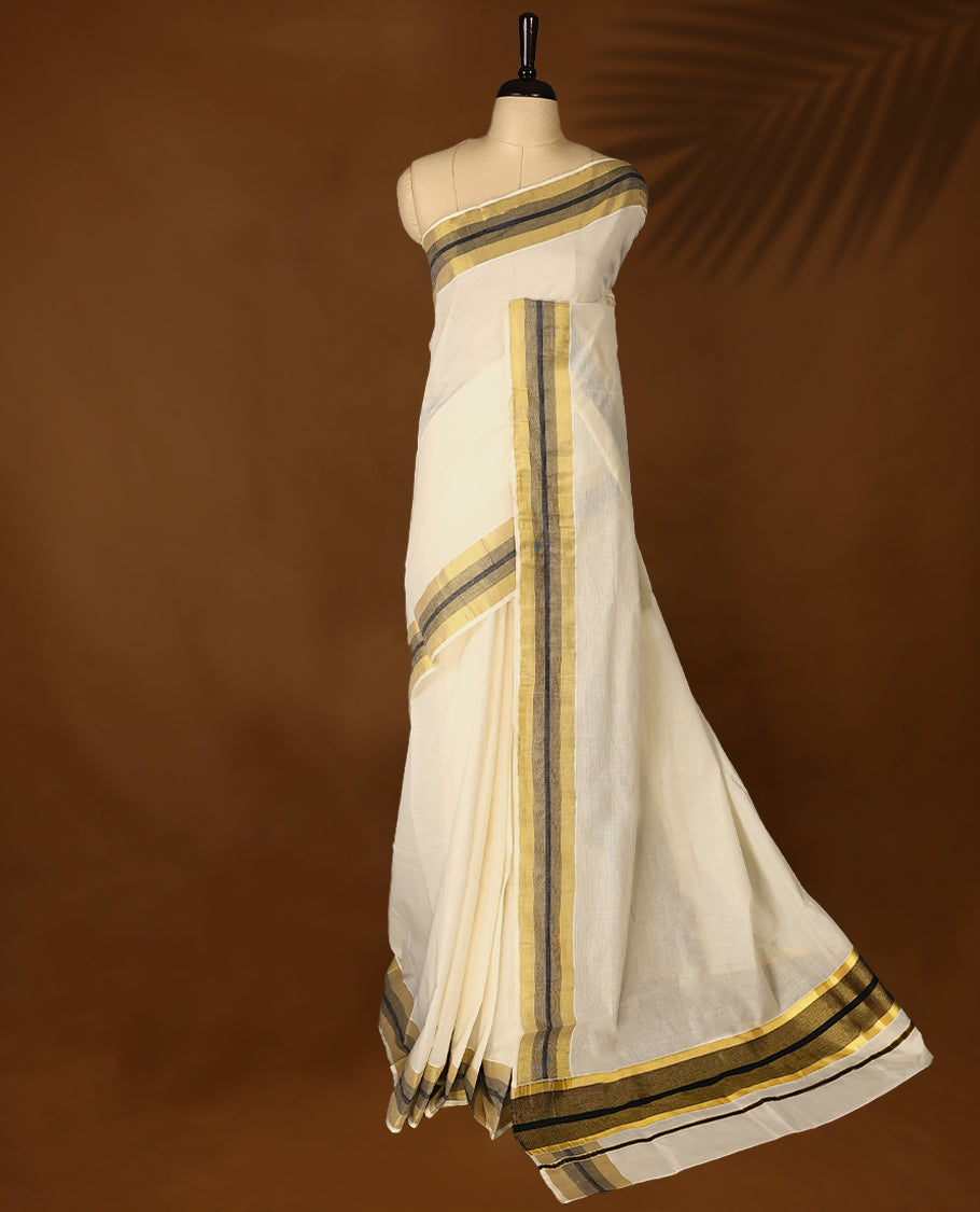 Elegant off white colour cotton Kerala saree featuring Plain body, Black colour & golden zari kasavu border offering a classic and graceful look, paired with a matching blouse.