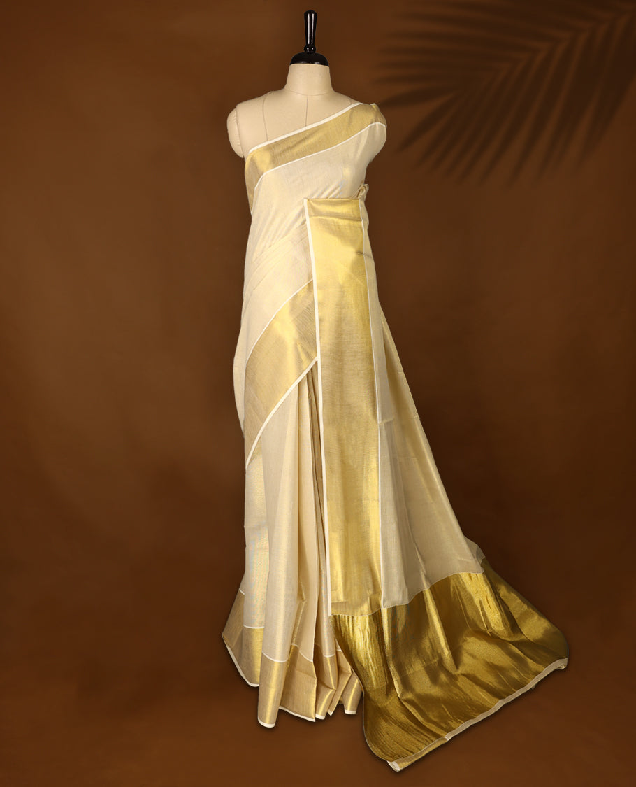 Light Gold colour Tissue Kerala saree featuring Plain body and a beautifully woven muted Gold Kasavu border, Grand Pallu paired with a matching blouse perfect for festive occasions.
