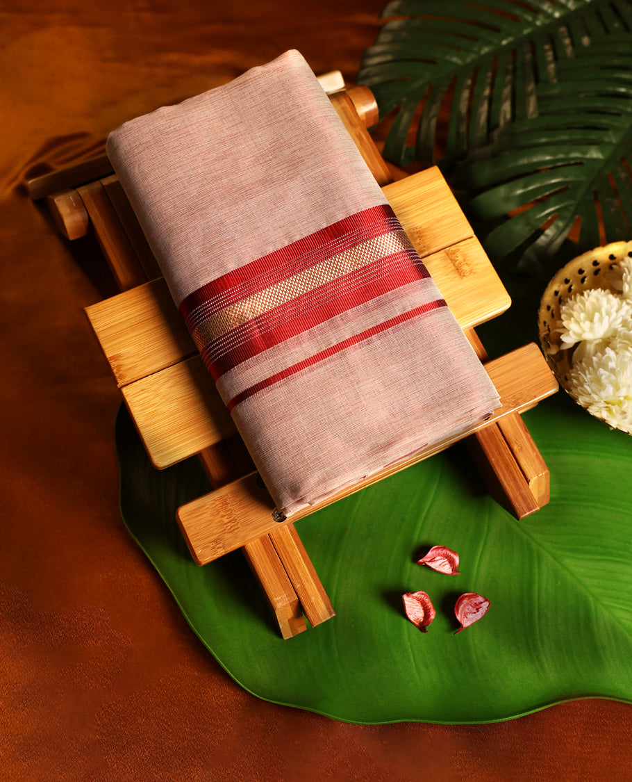 Soft brown pure handloom double dhoti featuring a rich maroon kara highlighted with golden zari and fine line detailing, woven with traditional craftsmanship for comfort, elegance, and festive occasions.