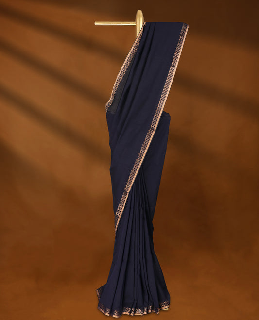 Navy Blue colour soft khadi cotton saree with plain body, detailed woven Gold zari border, paired pallu with tussles, with matching blouse.