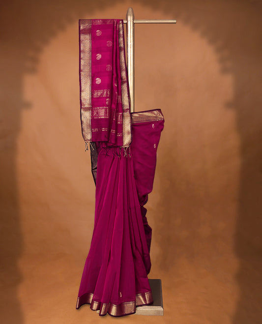 Deep Magenta colour Maheshwari Cotton saree featuring Antique Zari Mango Patterns across the entire body, complemented by a traditional Gold Zari border & Pallu, with a matching blouse.