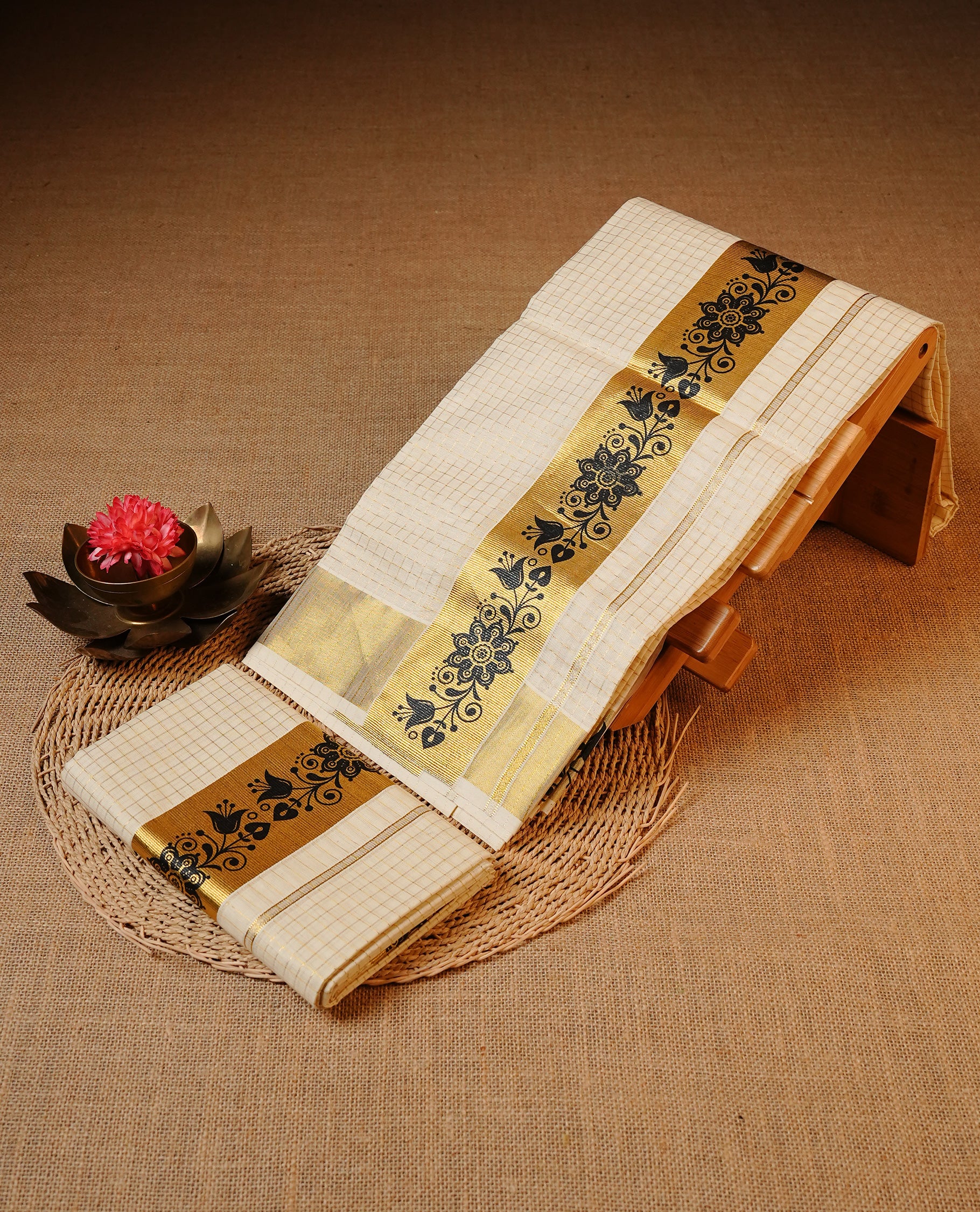 Off white colour Cotton Set Mund featuring a Check pattern body, enhanced by a gold zari kasavu border with Black Floral print detailing.