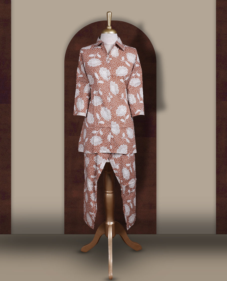 Soft brown colour cord set with bold white floral prints, Features a collared kurta with front buttons and 3/4 sleeves, paired with asymmetrical hem pants for a trendy and contemporary ethnic look.