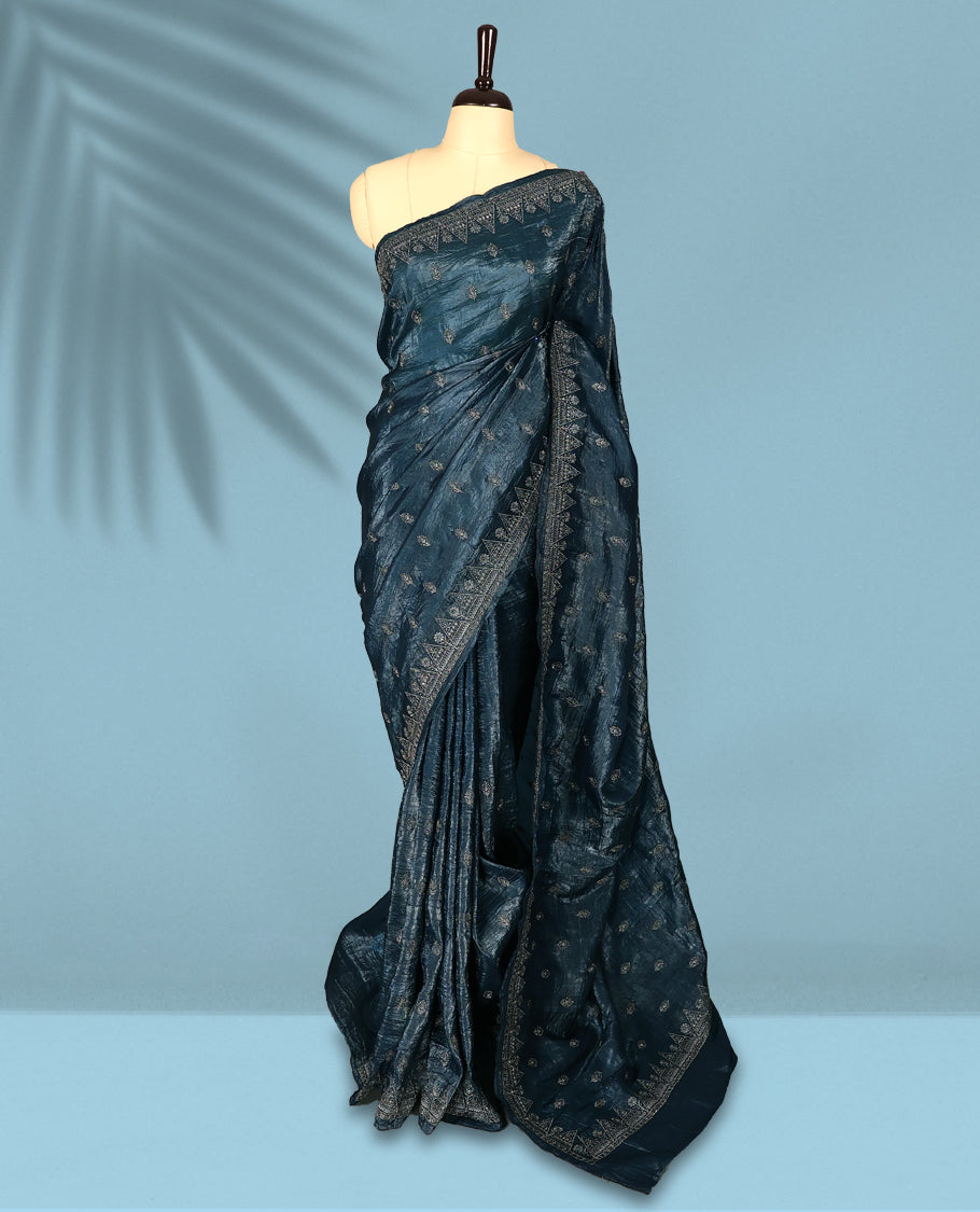 Midnight Blue Colour crush soft silk saree, textured body with a natural crinkled finish, adorned with intricate Silver colored floral Motifs and complemented by a delicate Silver Zari embroidery border, paired with a matching blouse