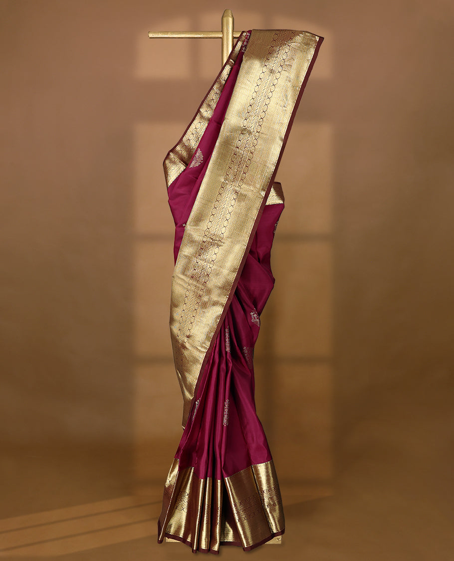 Mulberry coloured pure traditional Kancheepuram silk saree featuring antique zari floral motifs, complemented by a traditional self coloured border and a matching blouse.
