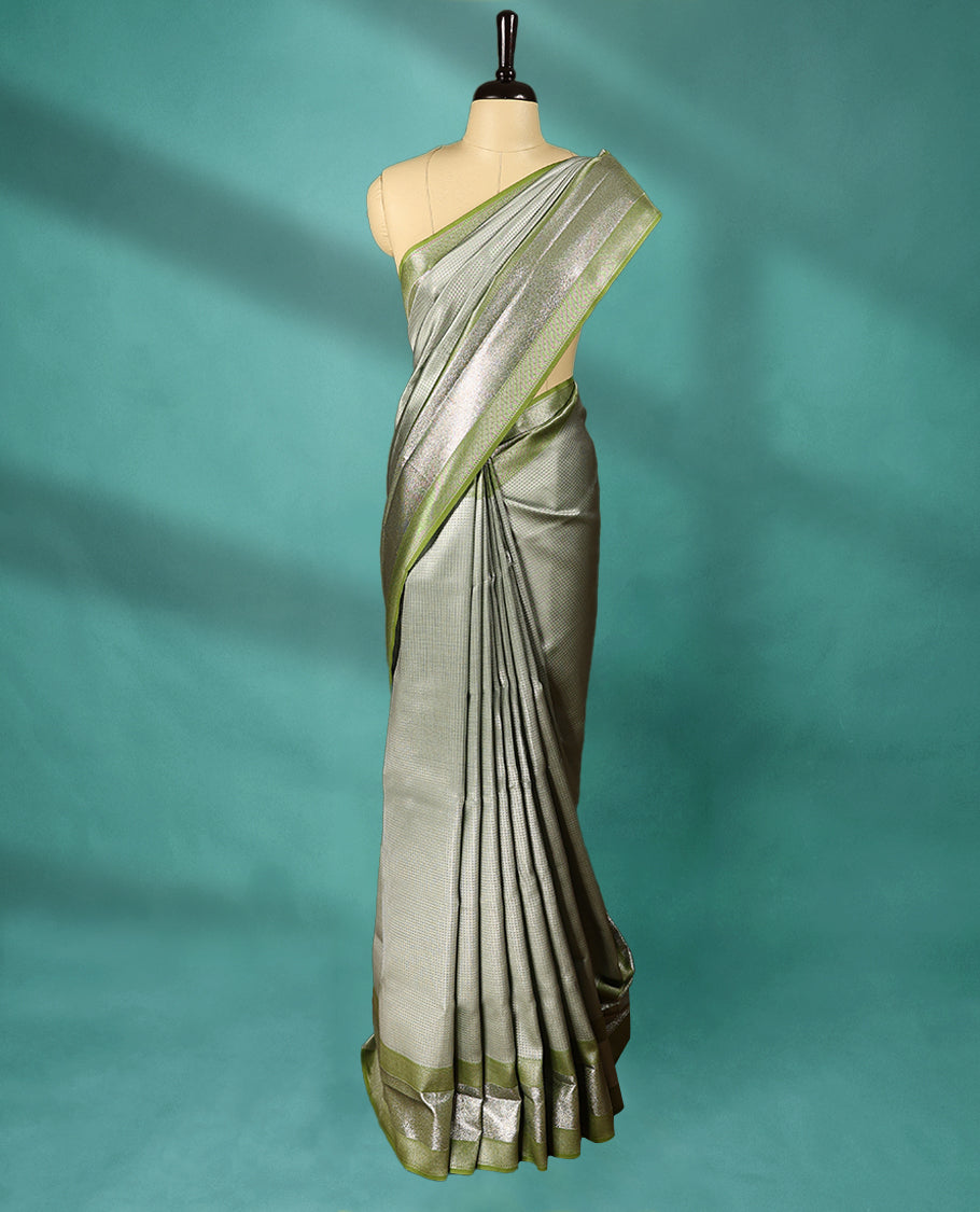 Greenish Grey coloured Art Soft Silk saree featuring a Check design on the body, paired with a Green coloured border and matching blouse.