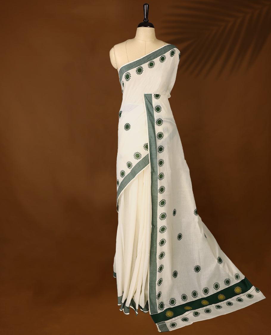Elegant off white colour cotton Kerala saree featuring Plain body, Green colour border with Flower Block prints, Paired with matching blouse offering a classic and graceful look