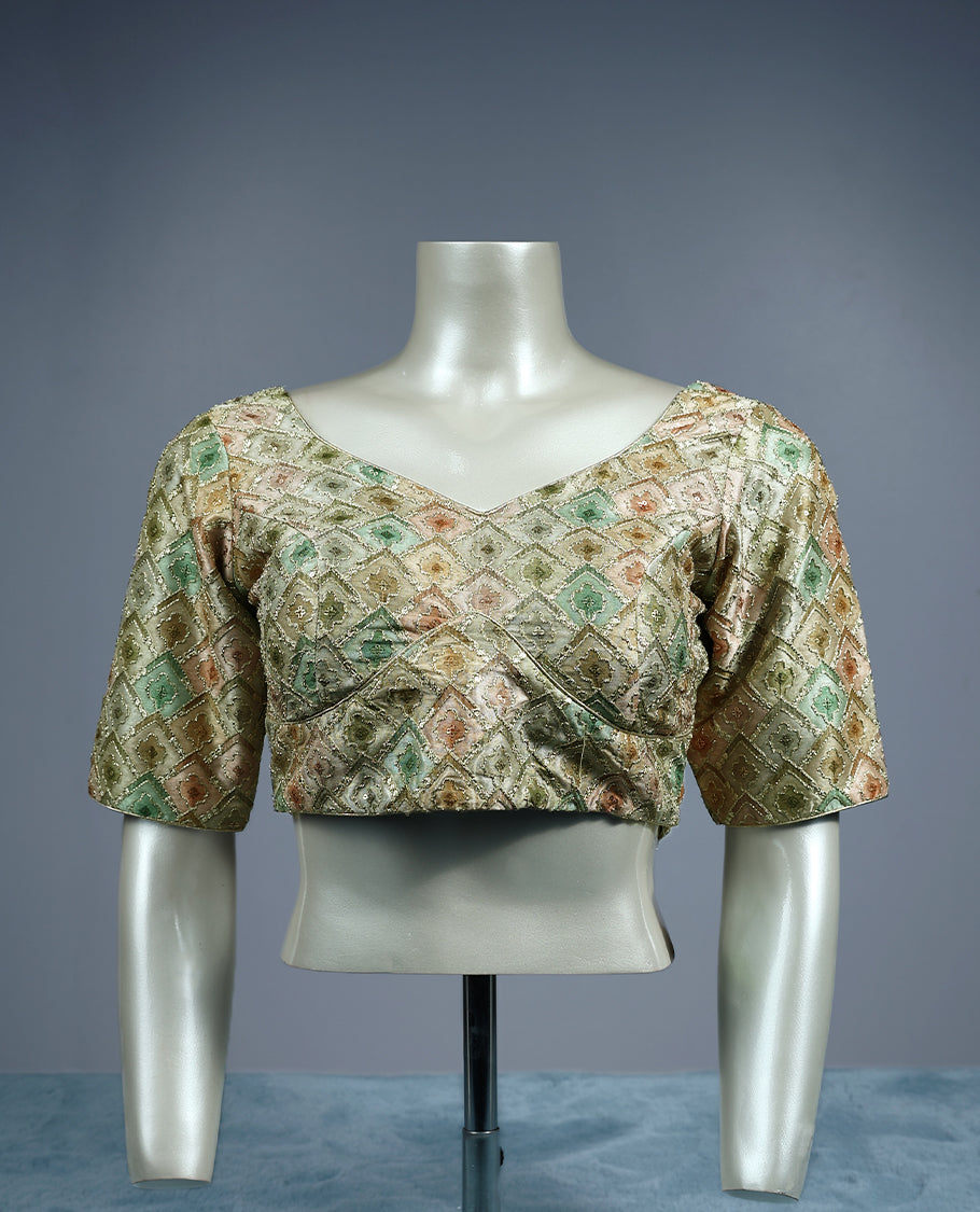 Pastel brocade padded readymade blouse featuring a diamond shaped multicolor weave in soft tones of sage green, peach, and gold, finished with elbow length sleeves and a flattering V neckline