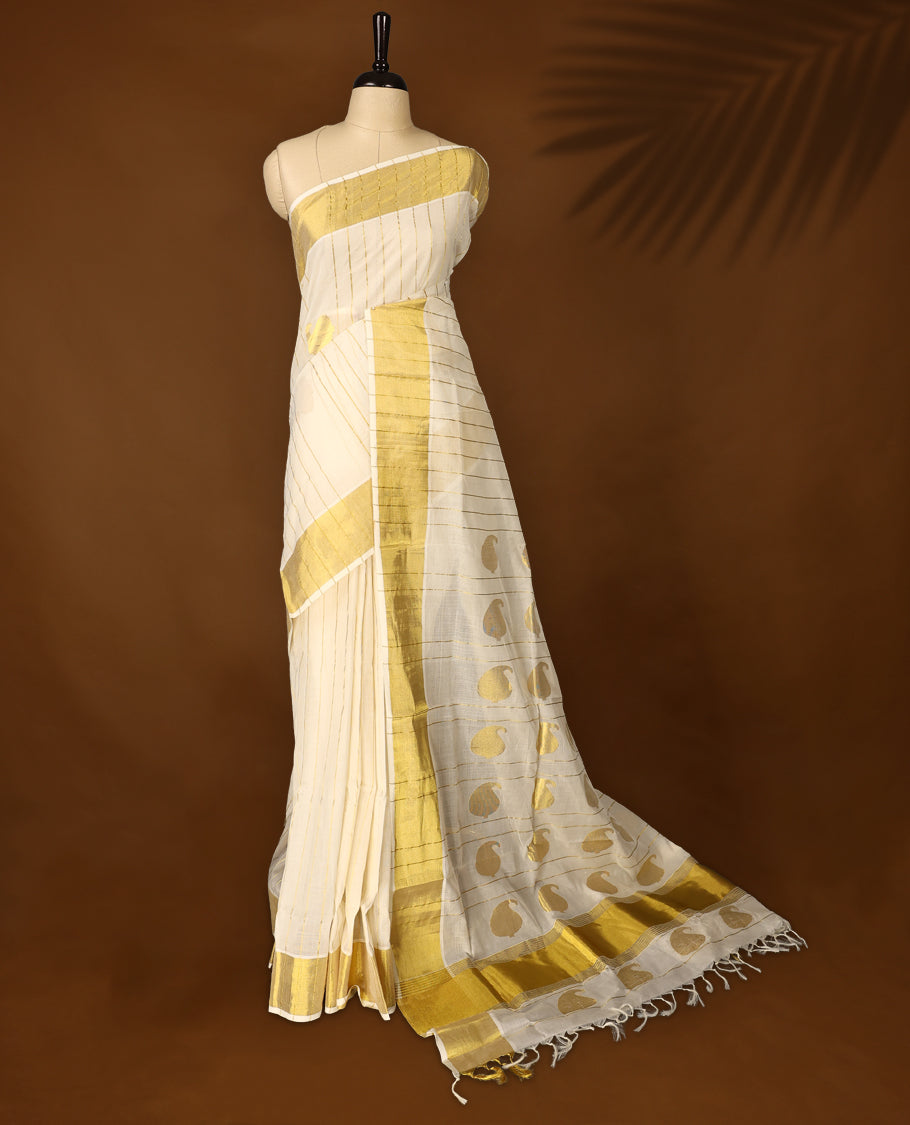 Elegant Pure handloom Kerala saree adorned with golden vertical stripes and traditional mango motifs, paired with a rich golden zari border & Comes with a matching blouse for a timeless ethnic look.