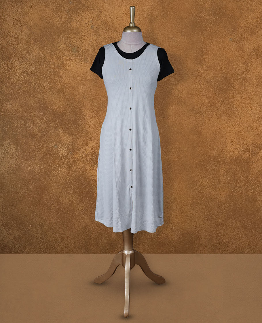 Light grey sleeveless A-line midi dress with front button detailing, layered over a black crew-neck short-sleeve inner tee.