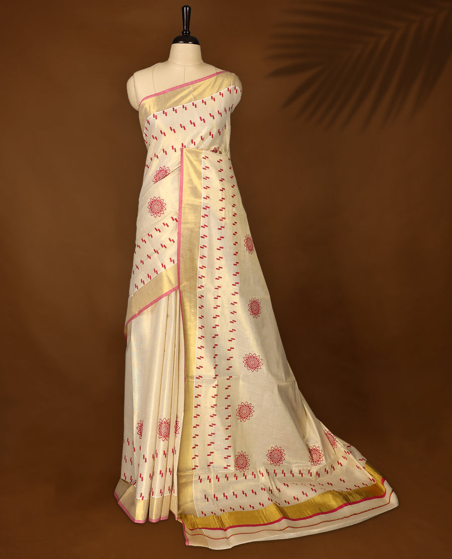 Elegant handloom soft tissue kerala saree in cream with gold zari border and pink detailing,Adorned with floral motifs and subtle stripes, paired with a matching blouse,perfect for festive and traditional occasions.