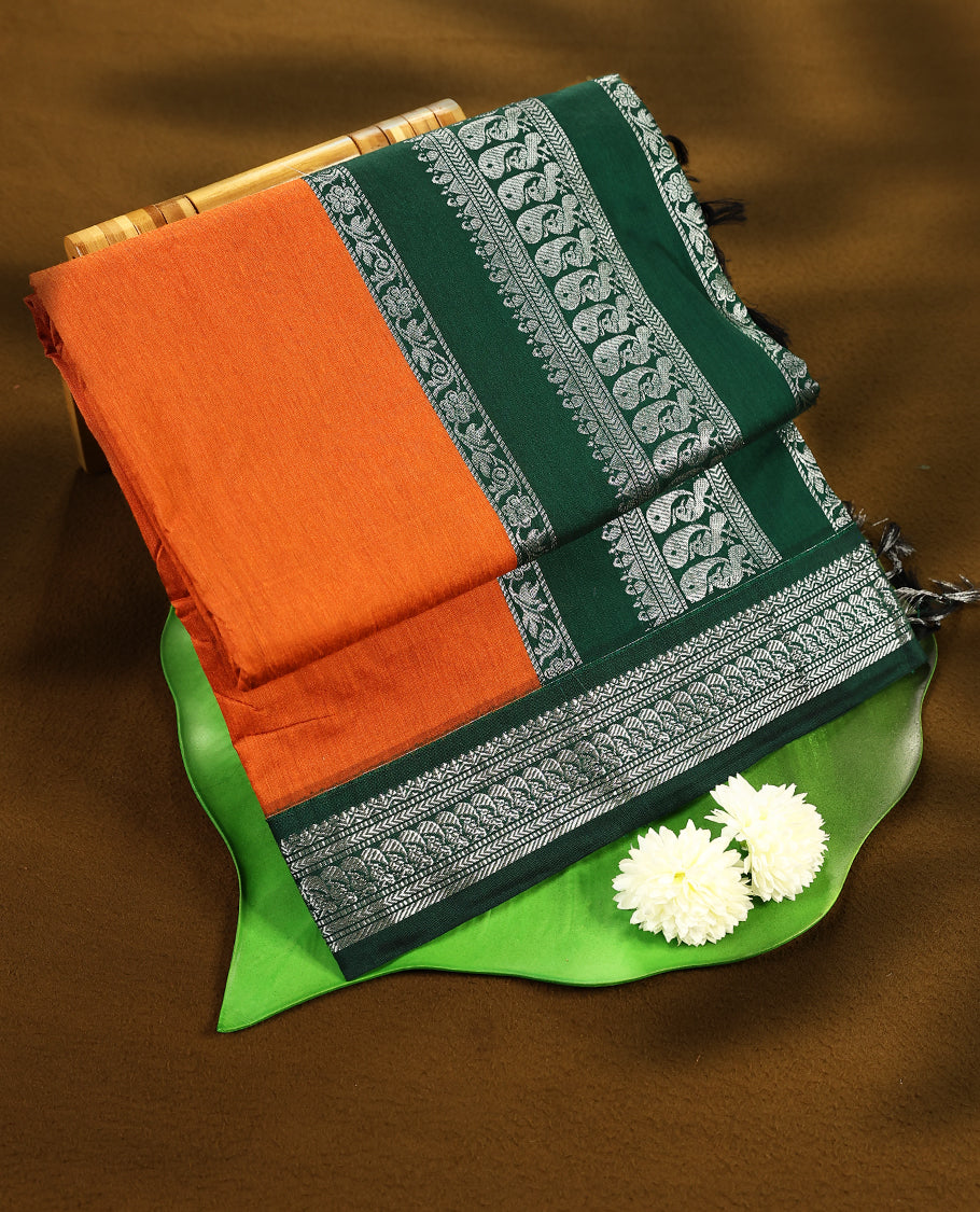 Rust Orange colour mixed Kalyani cotton saree featuring Plain body, paired with Bottle Green colour traditional border and pallu, with matching blouse