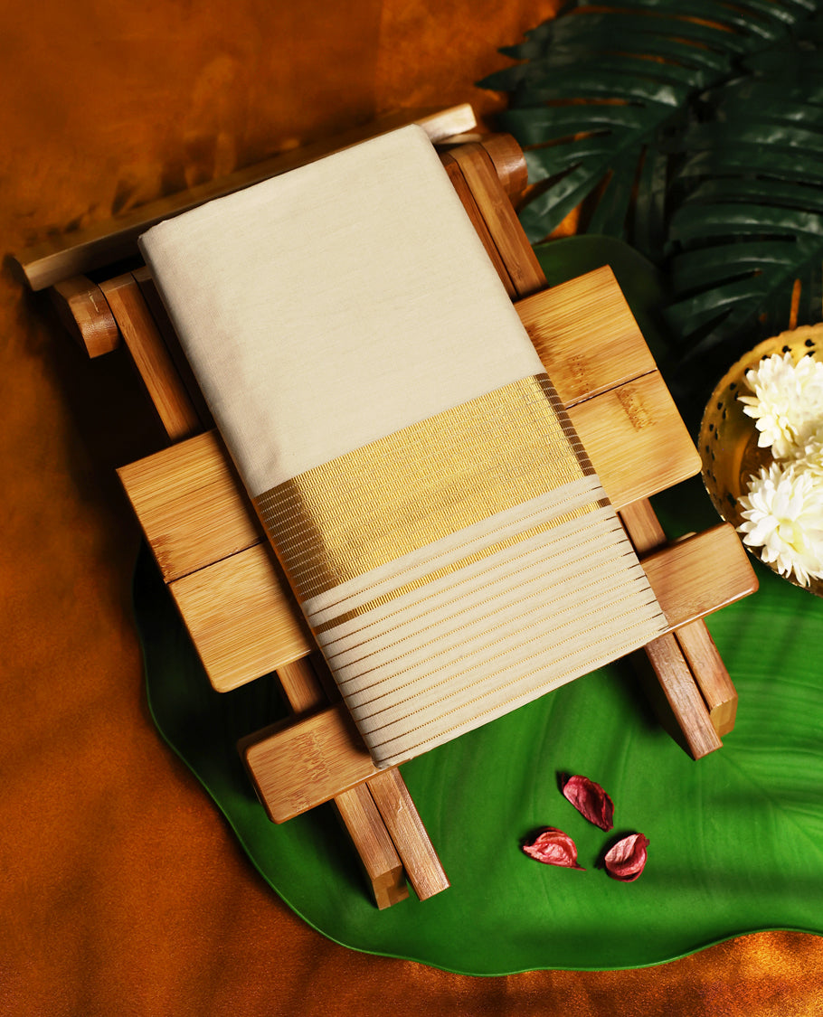 Elegant off white colour pure handloom cotton double dhoti in fine cotton, featuring a broad golden zari border with sleek parallel lines, crafted for timeless traditional charm and festive wear.