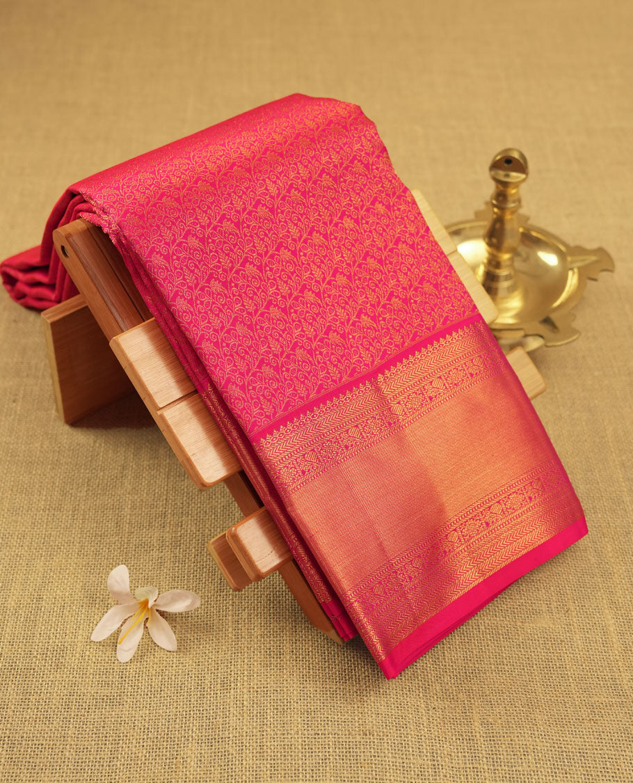 Rani pink colour Kanchipuram pattern Manthrakodi saree featuring golden zari traditional pattern and floral zari jacquard with small zari motifs across the body, traditional bavanji border, and plain zari blouse piece.