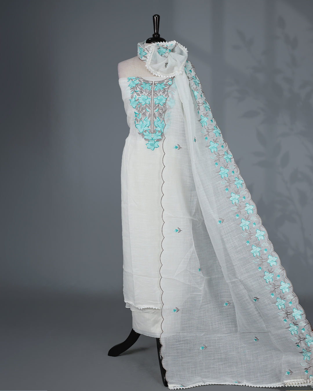 Off White Kotta Net Salwar Material featuring elegant aqua floral thread embroidery on yoke, paired with a matching bottom and an embroidered dupatta.