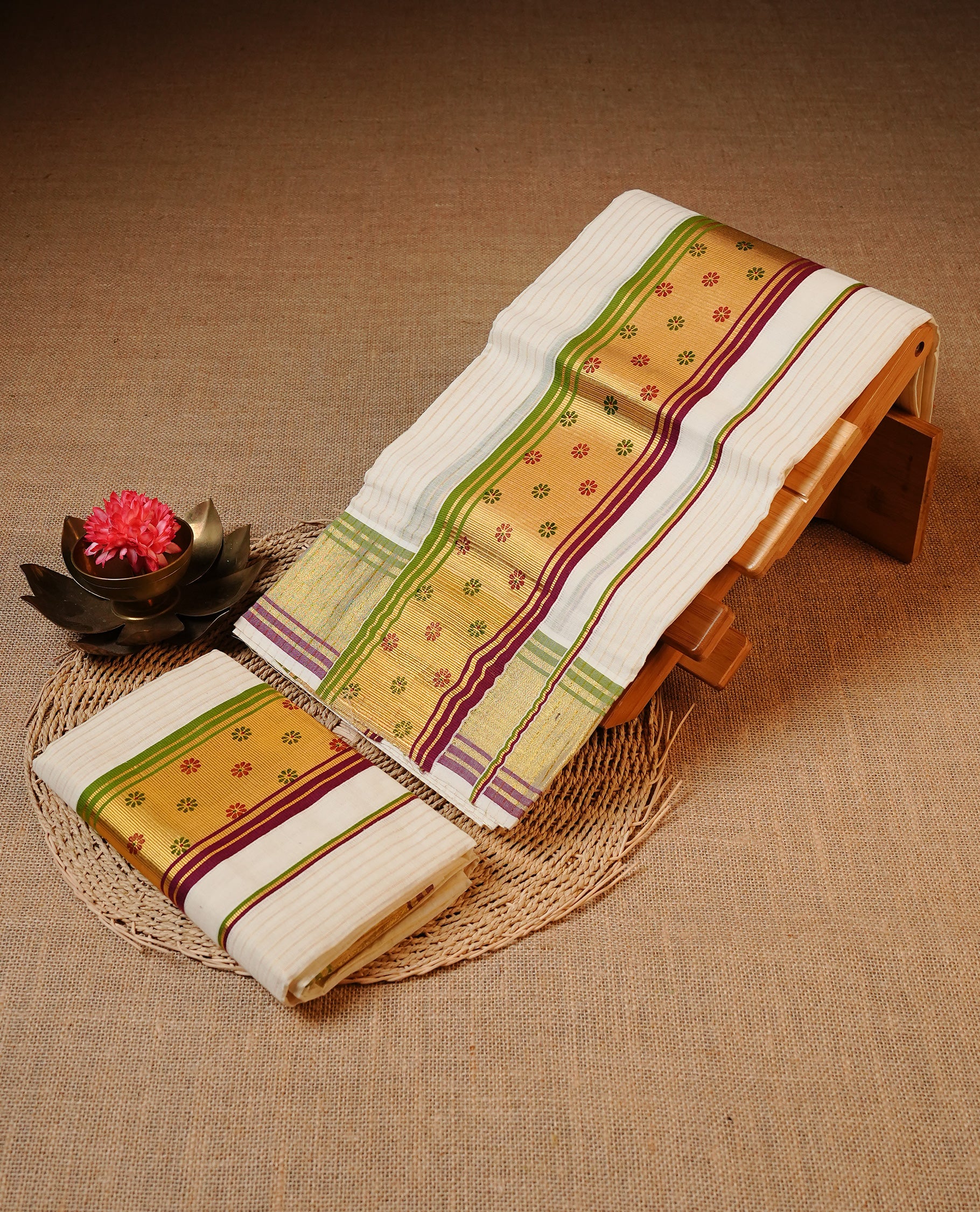 Off white colour Cotton Set Mund featuring a Stripes on body, enhanced by a Green & maroon colour with floral print on zari border.